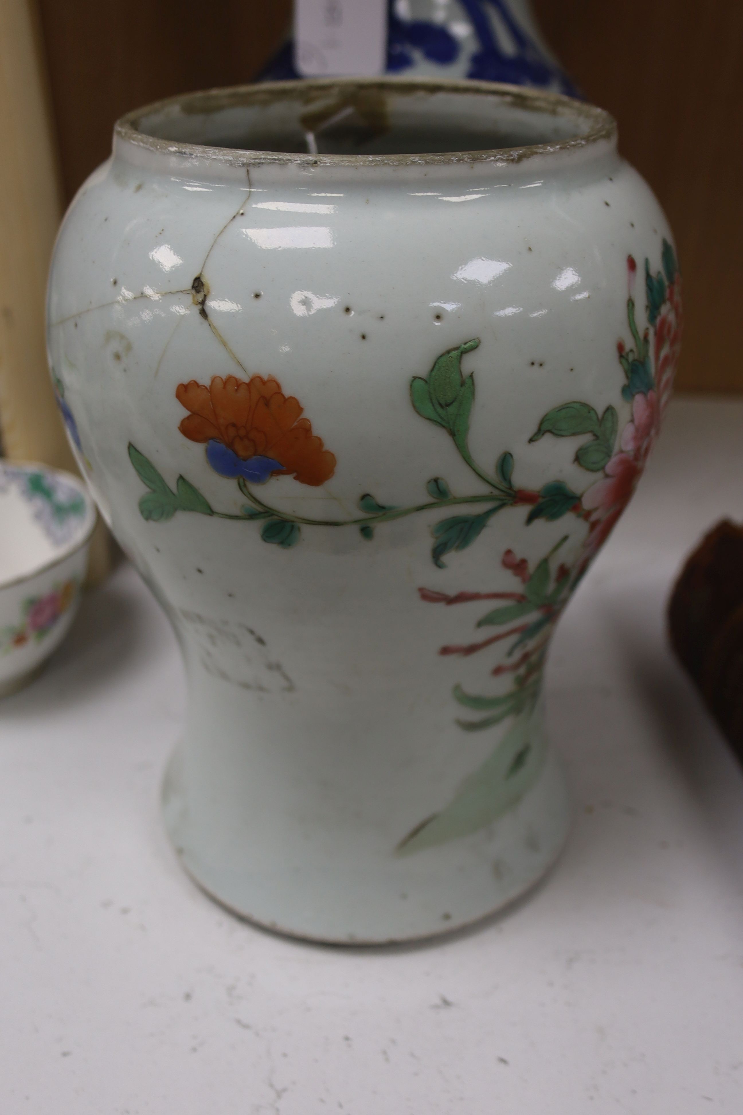 A Chinese blue and white 'Immortals' vase, 18th/19th century, damage, 34.5cm and a Chinese Yongzheng period famille rose ‘phoenix’ vase (reduced in height), 24cm